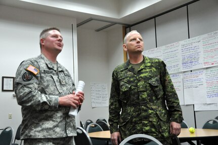 Army Maj. Gary Hildebrandt of the Wisconsin Army National Guard's 426th Regional Training Institute at Fort McCoy, Wis., briefs Canadian Brig. Gen. Paul Bury, deputy commander of Land Force Western Area/Joint Task Force West, on the 426th's Master Resiliency Trainer course during a visit May 9, 2012. Bury and Canadian Area Reserve Chief Warrant Officer Gordon Crossley visited various Wisconsin Army National Guard sites in an effort to observe Canadian Army Reserve soldiers participating in the 32nd Infantry Brigade Combat Team's Warfighter Exercise at Fort McCoy.