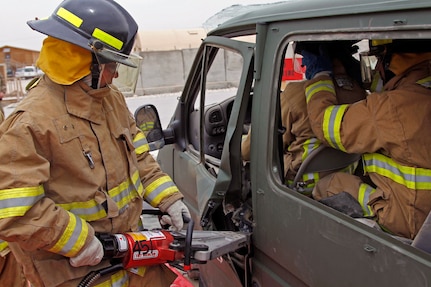 An Afghan National Air Force airman uses the spreader tool on the crash vehicle during vehicle extraction training exercise held here May 2, 2012. The training, facilitated by the South Dakota Army National Guard's 451st Engineer Detachment firefighters, provided hands on training of the tools and techniques to safely remove a victim from a vehicle accident. International Security Assistance Force Regional Command North supports Afghan National Security Forces in close coordination and collaboration in providing security and disrupting insurgent activities in order to protect the Afghan population.