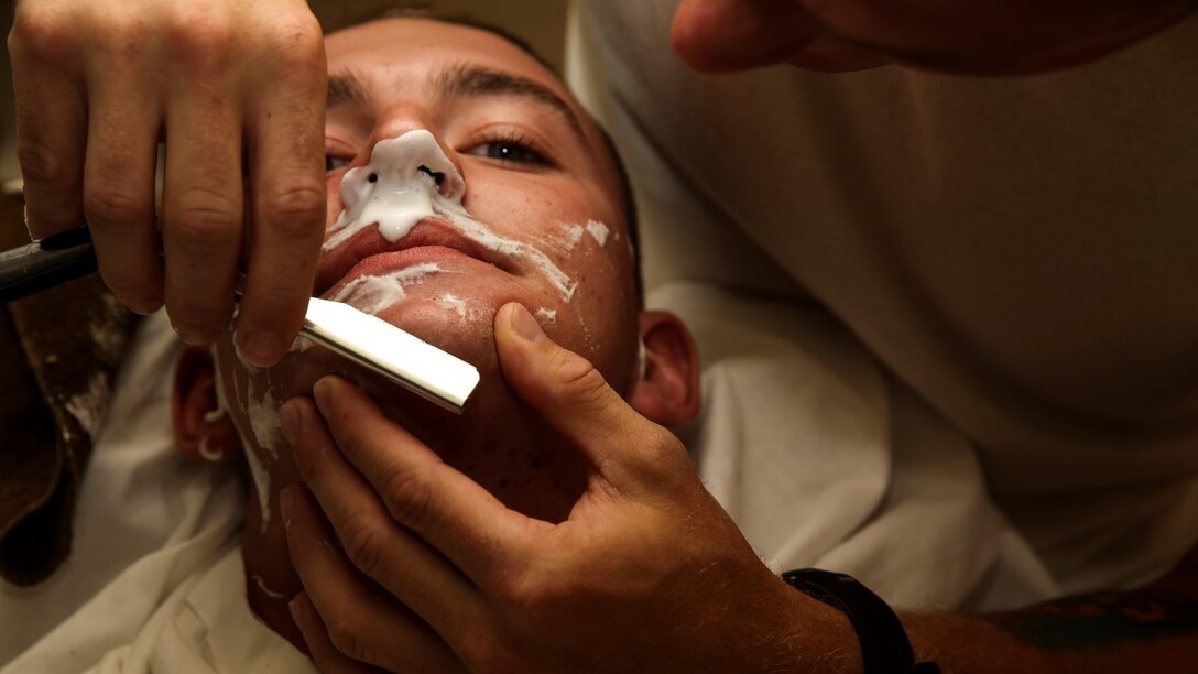 Corporal Carl Provost, automotive mechanic, 15th Marine Expeditionary Unit, shaves Lance Cpl. Lukasz Wlodkowski, automotive maintenance technician, Combat Logistics Battalion 5, at his home aboard Camp Pendleton, Calif. June 8, 2014. Provost is from Duluth, Minn. (U.S. Marine Corps photo by Lance Cpl. Anna Albrecht/Released)