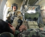 Army Sgt. Cliff Aughe, a flight medic with C Company, 1st Battalion, 171st Aviation Regiment, New Mexico Army National Guard, watches over a soldier from the Afghan National Army during an evacuation mission in Afghanistan March 27, 2012. 