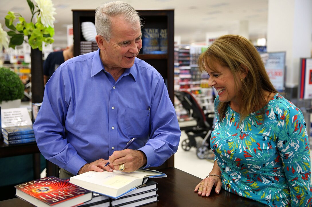 CAMP PENDLETON, Calif. - Oliver North, a retired Marine Corps colonel, meets with and signs a copy of his new book for Navy Capt. Barbra Trunzo at the Pacific Views Marine Corps Exchange here June 7.

Pendleton is among the first stops for North as part of his book promotion tour where he will travel across the country making more than 40 stops.  North said it was an easy decision to make Pendleton an early stop because "it is all about the Marines."

North is a best-selling author and host of the TV show War Stories.  Trunzo works at the Naval Hospital Camp Pendleton.