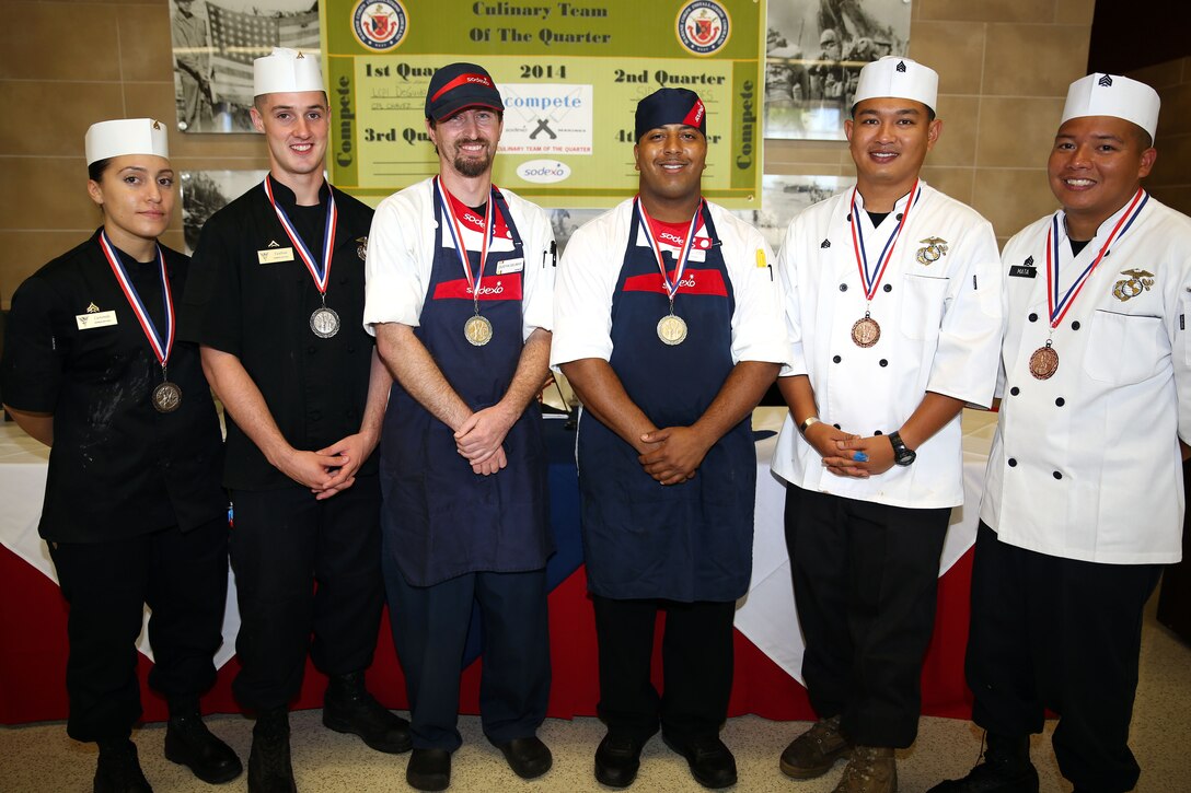 CAMP PENDLETON, Calif. - Three teams of two competed for the title of the Culinary Team of the Quarter at the 31 Area Mess Hall on Edson Range here June 11. The winners for this quarter were Team 1, Dustin Delmar and Anthony Stewart who work at the 33 Area Mess Hall here.

The competition is a two-day event.  On the first day, 12 teams competed in a book test and a Jeopardy-style quiz. Only four teams qualified to move on to the cooking portion of the competition the following day.

The theme of the cooking competition this third quarter was barbeque, and each team was expected to make a protein dish using chicken or pork, cornbread and a salad. For the first time this quarter the competition included 45 minutes of assistance to each team from guest chef Rahm Fama.

This competition is used not only as an training tool, but also to build camaraderie among the food service community, said Donovan Brown, the Marine Corps Installations West regional executive chef.

From Left to Right: 2nd place winners Cpl. Katherine Castaneda and Lance Cpl. Stephen Van Hout, 1st place winners Dustin Delmar and  Anthony Stewart, and 3rd place winners Sgt. Raphael Castillo and Sgt. Matthew Mata.
