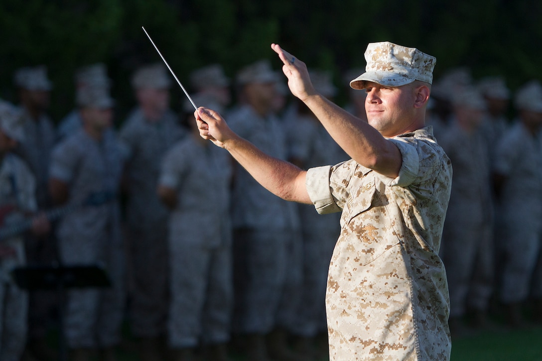Sgt. Erich Woolley, an enlisted conductor and musician with the 3rd Marine Aircraft Wing Band, conducts a tune during an evening colors ceremony aboard Marine Corps Air Station Miramar, Calif., June 10. The ceremony recognized the San Diego Chargers for their service to military members in surrounding communities. The event featured 3rd MAW and MCAS Miramar noncommissioned officers as part of the Committed and Engaged Leadership initiative, originated by Maj. Gen. Steven Busby, 3rd MAW commanding general.