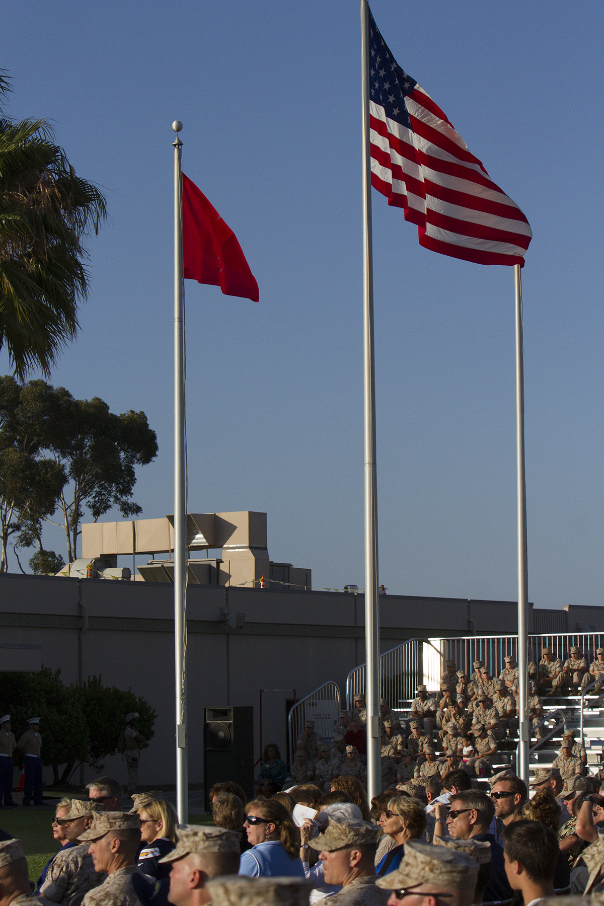 An American flag and two-star flag fly above the crowd of Marines and Sailors gathered for an evening colors ceremony aboard Marine Corps Air Station Miramar, Calif., June 10. The ceremony recognized the San Diego Chargers for their service to military members in surrounding communities. The event featured 3rd Marine Aircraft Wing and MCAS Miramar noncommissioned officers as part of the Committed and Engaged Leadership initiative, originated by Maj. Gen. Steven Busby, 3rd MAW commanding general.
