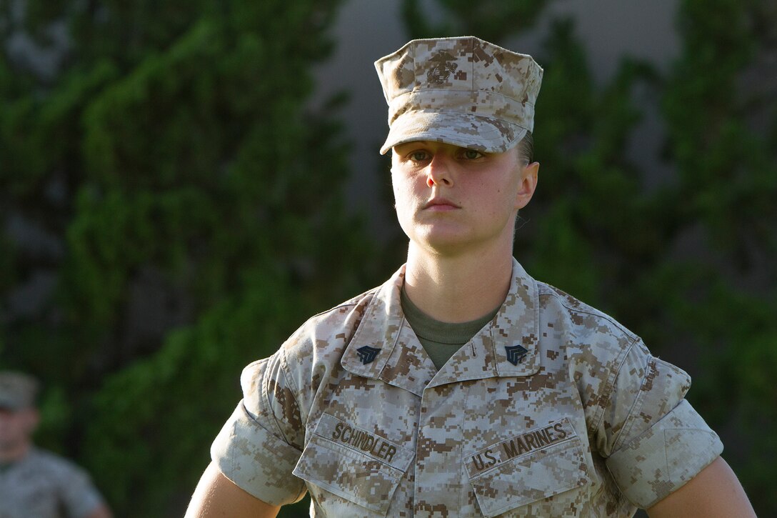 Sgt. Lindsey Schindler, commander of troops and crew master with Marine Aerial Refueling and Transportation Squadron (VMGR) 352, stands at parade rest during an evening colors ceremony aboard Marine Corps Air Station Miramar, Calif., June 10. The ceremony recognized the San Diego Chargers for their service to military members in surrounding communities. The event featured 3rd Marine Aircraft Wing and MCAS Miramar noncommissioned officers as part of the Committed and Engaged Leadership initiative, originated by Maj. Gen. Steven Busby, 3rd MAW commanding general.