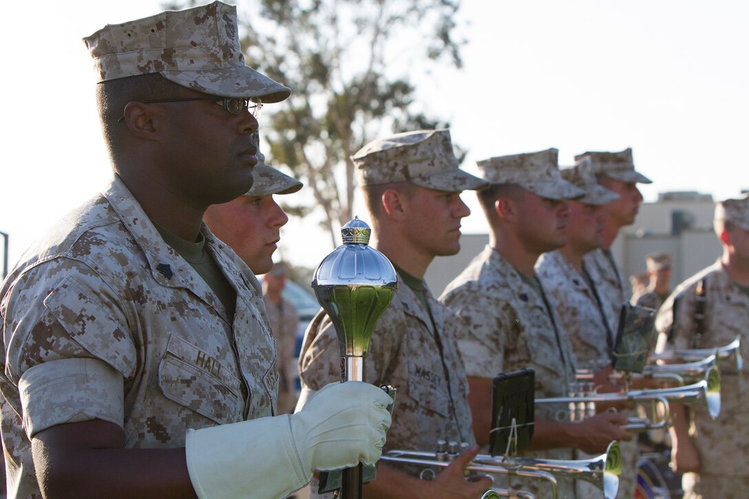 Sgt. Johnte Hall, drum major and musician with the 3rd Marine Aircraft Wing Band, stands during an evening colors ceremony aboard Marine Corps Air Station Miramar, Calif., June 10. The ceremony recognized the San Diego Chargers for their service to military members in surrounding communities. The event featured 3rd MAW and MCAS Miramar noncommissioned officers as part of the Committed and Engaged Leadership initiative, originated by Maj. Gen. Steven Busby, 3rd MAW commanding general.
