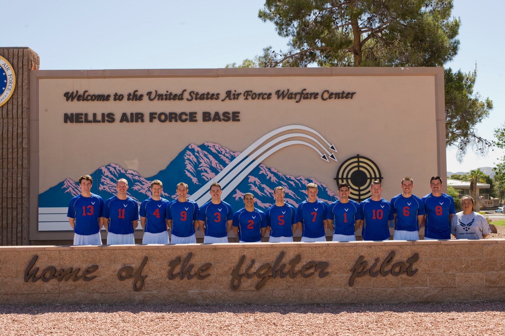 1st Lt. Jonathan Fullenkamp, #9, poses for a team photo May 21 with the 2014 All-Air Force Men's Volleyball team after finding out he was selected after try outs at Nellis AFB, Nev. Fullenkamp is an Air Force Research Laboratory, Detachment 7, Advanced Tactical Booster Demonstration deputy program manager. (U.S. Air Force photo by Senior Airman Christopher Tam)