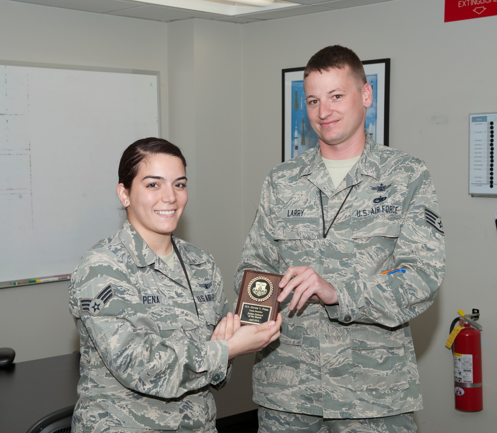 Senior Airman Alyssa Pena, 460th Operations Group, is awarded the Junior Enlisted of the Month award. The JEoM award is given to the most deserving Airmen who have not only shown hard work, supreme leadership and dedication to their job, but also put forth significant effort into bettering themselves and the community. (U.S. Air Force photo by Airman 1st Class Samantha Saulsbury/Released)