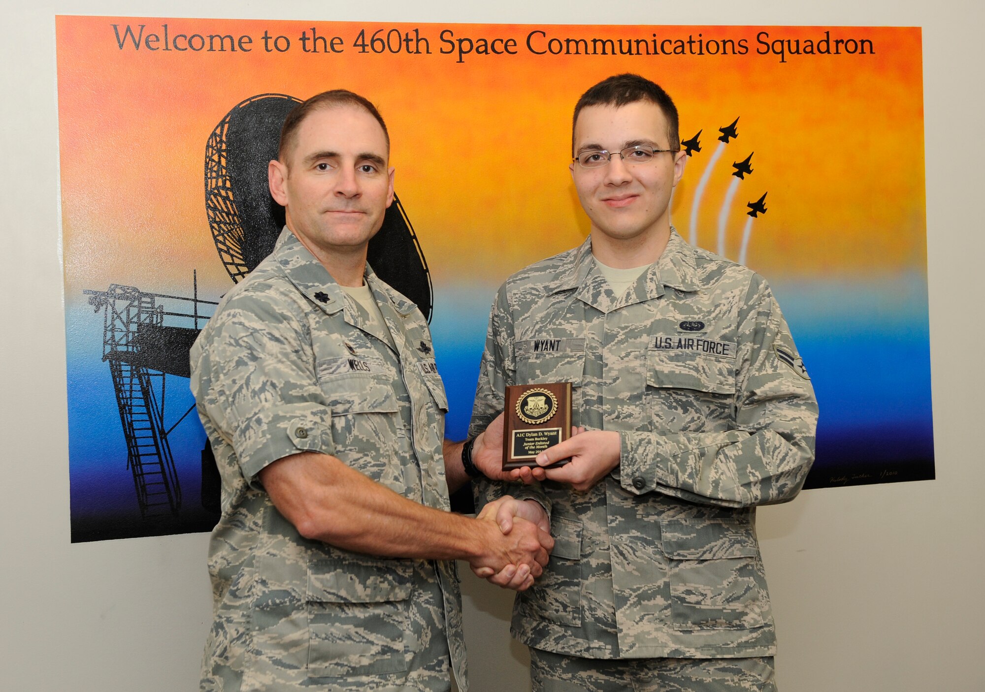 Airman 1st Class Dylan Wyant, 460th Space Communication Squadron, is awarded the Junior Enlisted of the Month award. The JEoM award is given to the most deserving Airmen who have not only shown hard work, supreme leadership and dedication to their job, but also put forth significant effort into bettering themselves and the community. (U.S. Air Force photo by Airman 1st Class Samantha Saulsbury/Released)