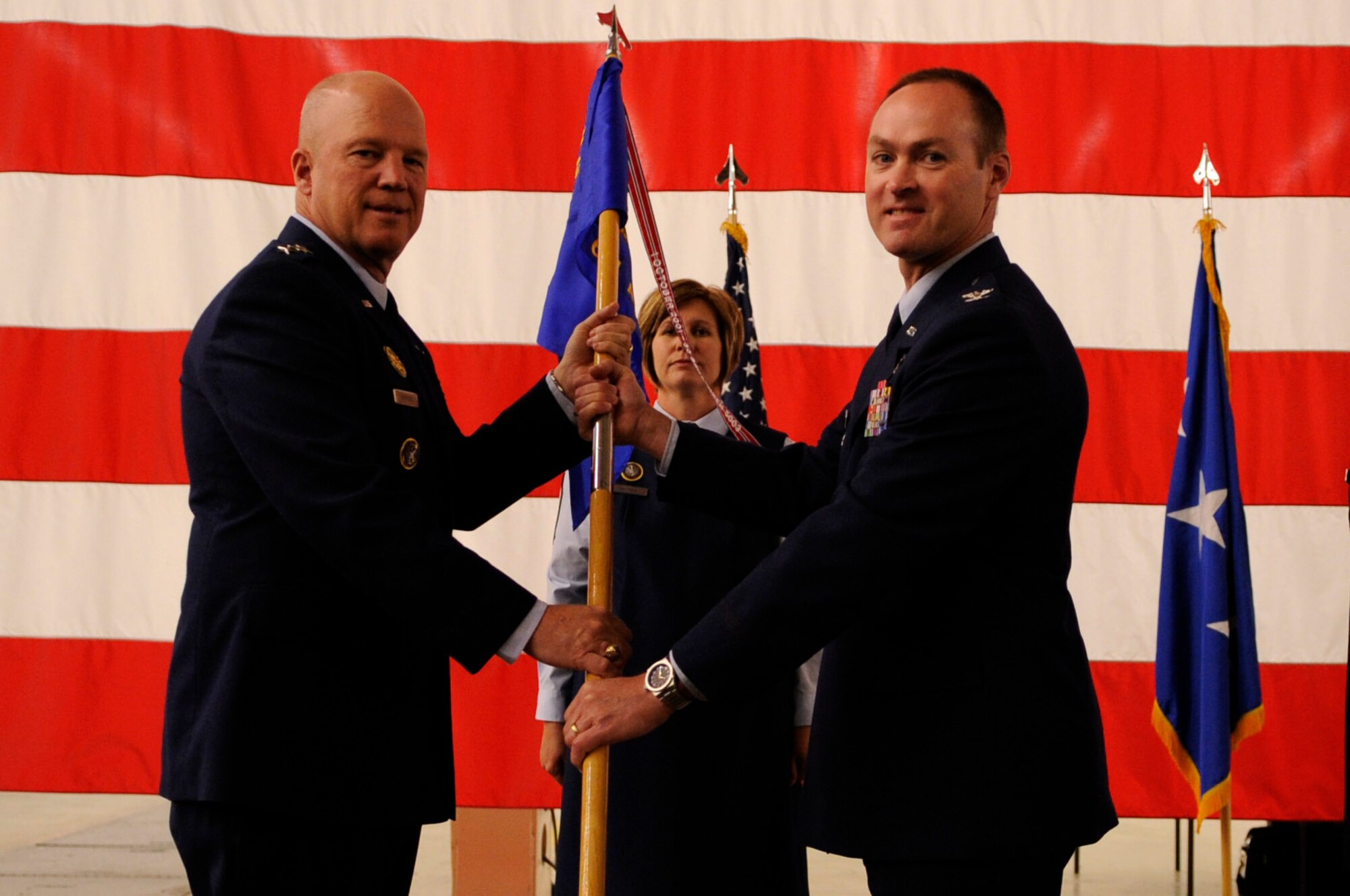Col. John Giles assumed command of the 614th Air and Space Operations Center during a ceremony at Vandenberg Air Force Base, Calif., June 6, 2014. Lt. Gen. John W. “Jay” Raymond, commander of U.S. Strategic Command's Joint Functional Component Command for Space and 14th Air Force (Air Forces Strategic), presided over the ceremony, during which Col. John Wagner relinquished command to Giles. (U.S. Air Force photo by/Senior Airman Shane Phipps) 
