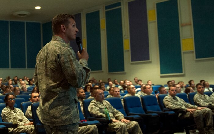 Col. Barry Cornish, 99th Air Base Wing commander, briefs Airmen on the importance of sexual assault prevention at the base theater June 6, 2014, at Nellis AFB, Nev.  Nellis AFB stood down for the day to focus on sexual assault response and prevention training. (U.S. Air Force photo by Airman 1st Class Rachel Loftis)