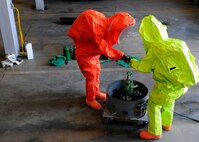 Senior Airmen Andrew Atkins and Jessica Wissenbach, 419th Civil Engineer Squadron, work together to neutralize a simulated gas leak at Hill Air Force Base, Utah, June 8, 2014. Atkins and Wissenbach complete the training annually to maintain their hazardous material technician certificate. (U.S. Air Force photo/Senior Airman Allen Stokes)
