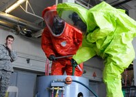 Senior Airmen Andrew Atkins and Jessica Wissenbach, 419th Civil Engineer Squadron, work together to neutralize a simulated gas leak at Hill Air Force Base, Utah, June 8, 2014. Atkins and Wissenbach complete the training annually to maintain their hazardous material technician certificate. (U.S. Air Force photo/Senior Airman Allen Stokes)