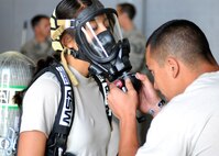 Senior Airman Jessica Wissenbach, 419th Civil Engineer Squadron, suits up before putting her hazardous materials training to the test at Hill Air Force Base, Utah, June 8, 2014. (U.S. Air Force photo/Senior Airman Allen Stokes)