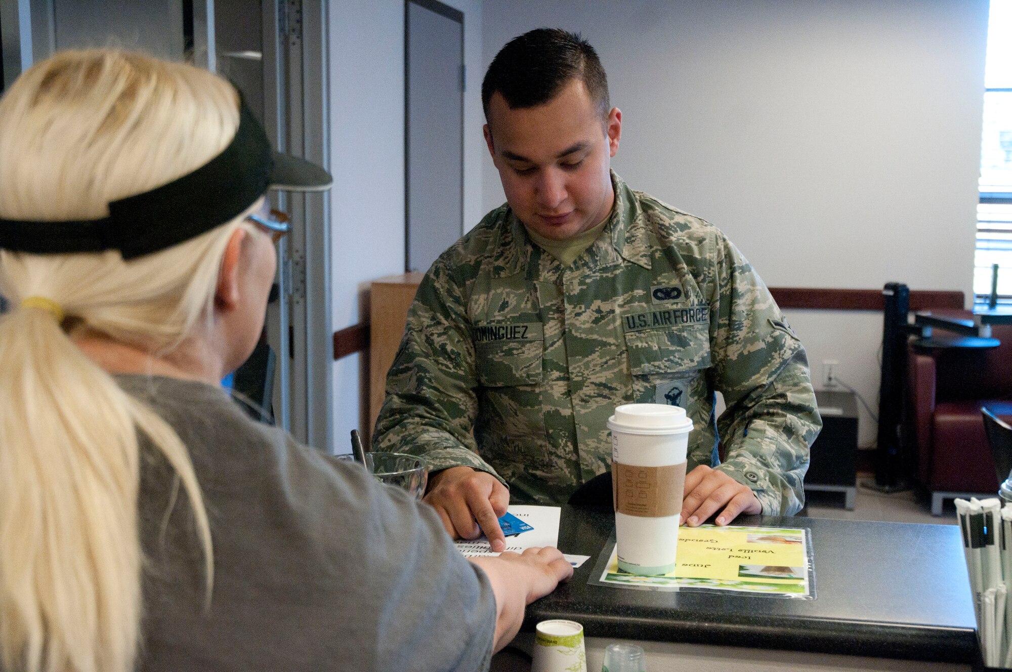 Airman Marvin Dominguez, 790th Missile Security Forces Squadron, receives a free coffee from the First Sergeant’s Counsel June 10, 2014, in the Fall Hall Starbucks. The counsel divided $300 around several food and beverage vendors on base so Airmen could get a free drink or meal. (U.S. Air Force photo by Airman Malcolm Mayfield)
