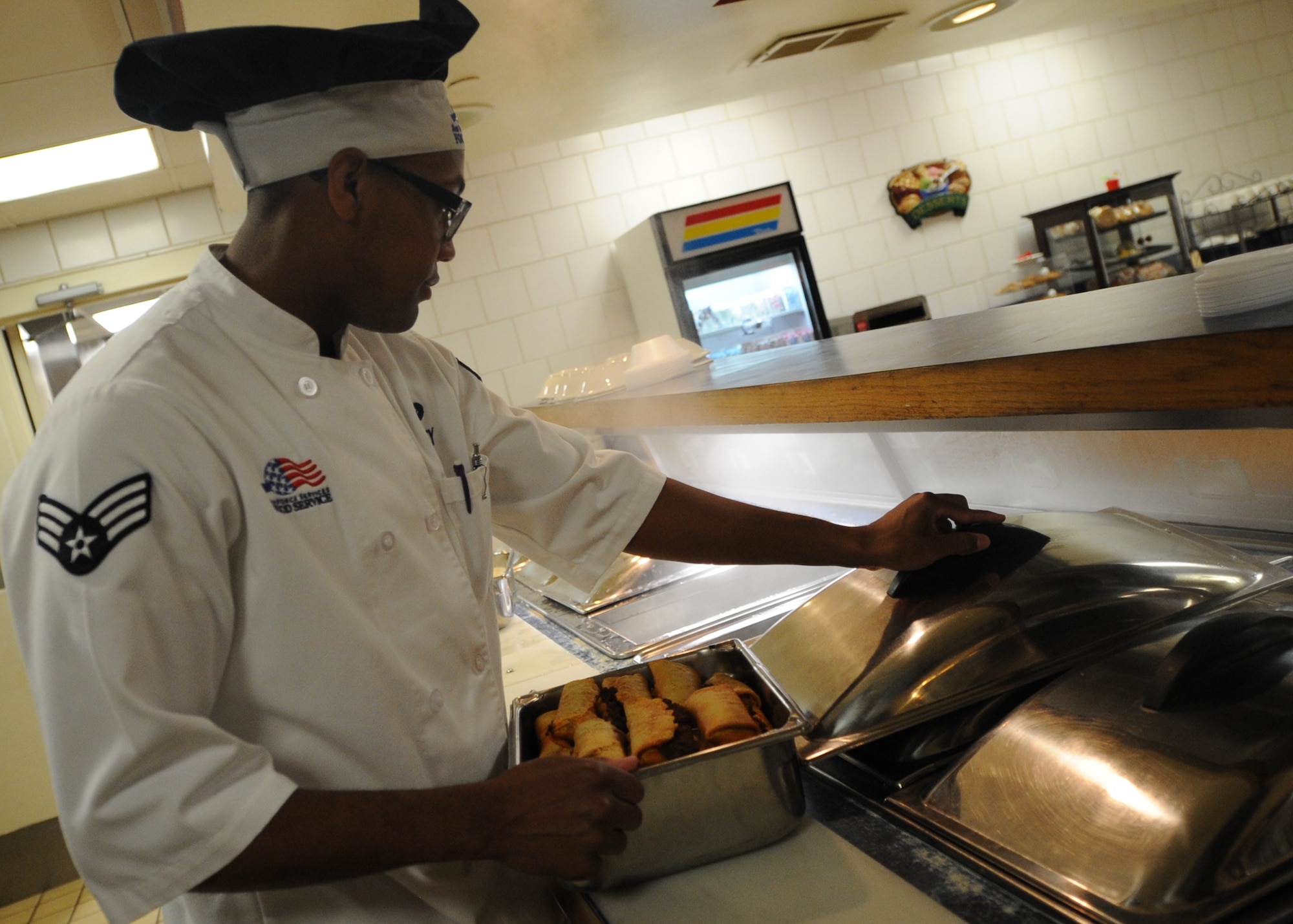 ALTUS AIR FORCE BASE, Okla. – U.S. Air Force Senior Airman Dearon Wiley, 97th Force Support Squadron food service technician, prepares burritos at the Solar Inn Dining Facility June 6, 2014. The dining facility consists of 30 workers who are constantly preparing to provide more than 2,500 meals a week for Airmen including breakfast, lunch, dinner and a midnight meal. (U.S. Air Force photo by Senior Airman Levin Boland/Released) 