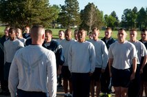 The 90th Logistics Squadron forms up for the end of their memorial run June 10, 2014, which memorialized Airman 1st Class Eric Barnes, an Airman who died on June 10, 2007, from a roadside bomb during a tour in Iraq. Lead by Master Sgt. Ricardo Borecki, 90th LRS first sergeant, the squadron run went from the Freedom Hall Fitness Center to the Contracting Squadron and back. (U.S. Air Force photo by Airman Malcolm Mayfield)