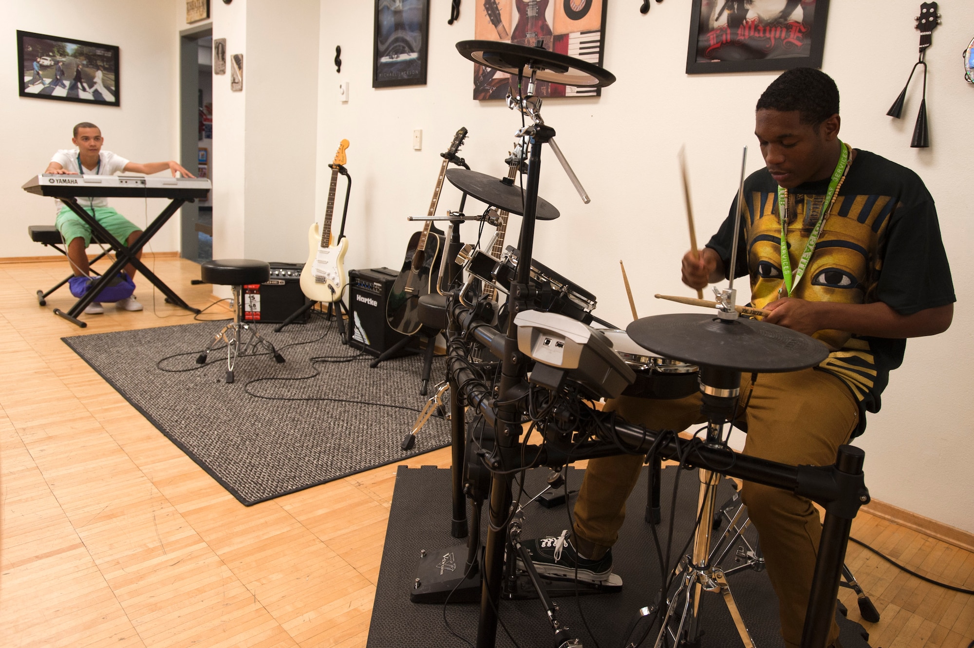 Caleb (left) and Jeremiah create music at the 99th Force Support Squadron Youth Center June 5, 2014, at Nellis Air Force Base, Nev. Instruments are available to teens as a way of encouraging creativity. (U.S. Air Force photo by Senior Airman Timothy Young)