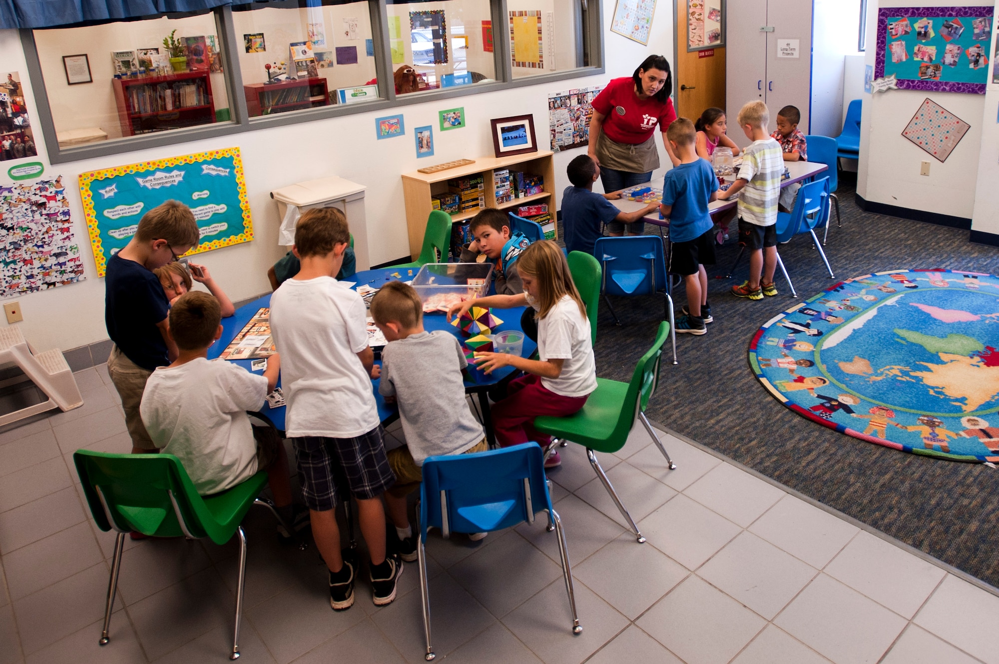 Children play board games in the game room of the 99th Force Support Squadron Youth Center June 5, 2014, at Nellis Air Force Base, Nev. The youth center offers projects aimed at condoning social interaction between children. (U.S. Air Force photo by Senior Airman Timothy Young)