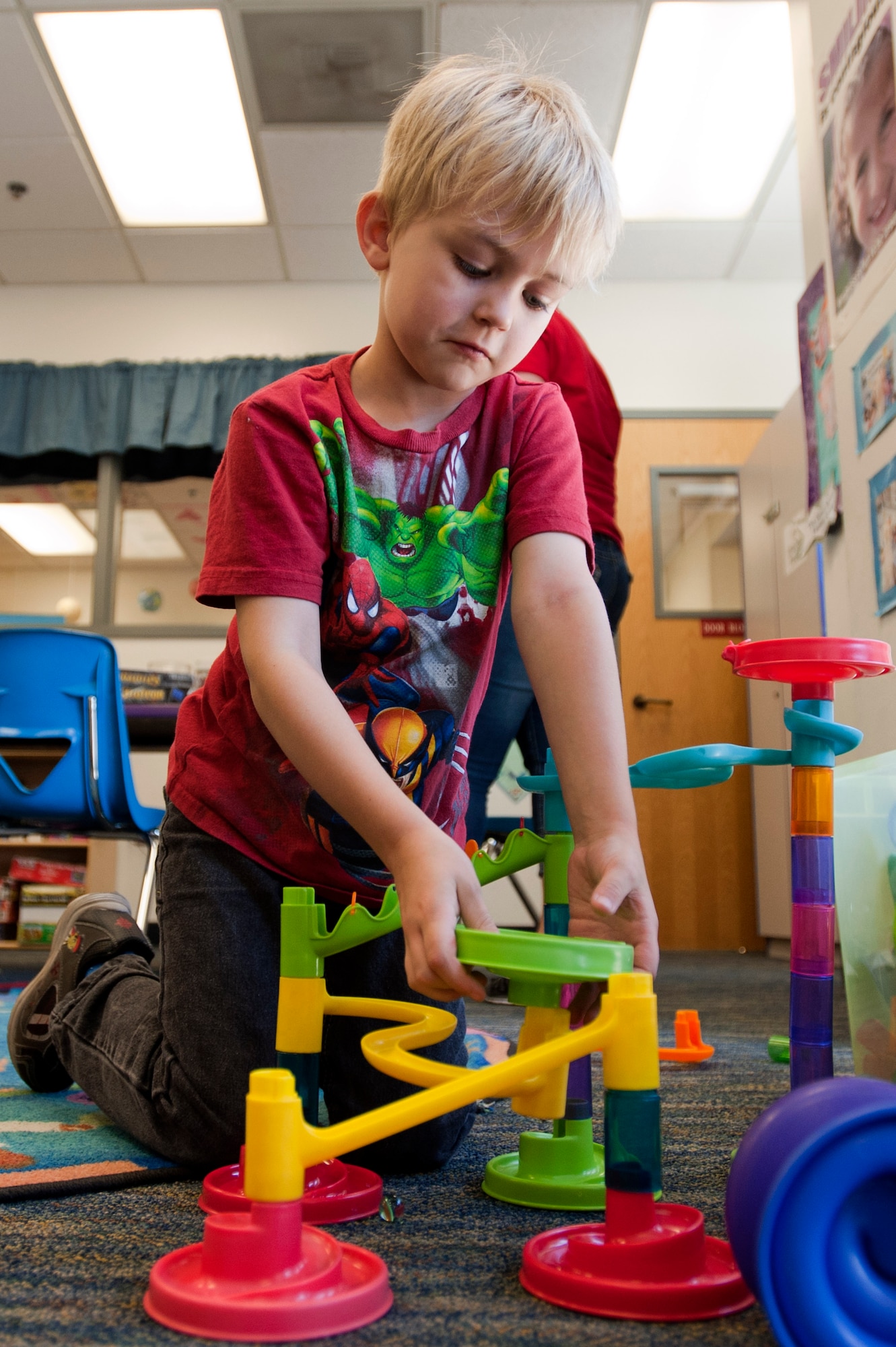 Kaleb connects pieces of a track in the game room of the 99th Force Support Squadron Youth Center June 5, 2014, at Nellis Air Force Base, Nev.  The youth center offers a variety of programs to develop artist and social skills.  (U.S. Air Force photo by Senior Airman Timothy Young)