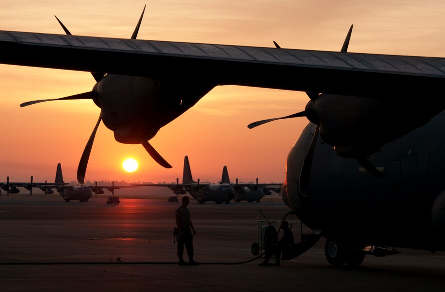 Crew chiefs from the 317th Airlift Group, Dyess Air Force Base, Texas, wait for aircrews to board a C-130J Super Hercules June 7, 2014, at Pope Army Airfield, Fort Bragg, North Carolina. The 317th AG transported nearly 1,500 soldiers and more than 57,000 pounds of equipment while supporting a Joint Forcible Entry Exercise and Joint Airborne/ Air Transportability Training. (U.S. Air Force photo by Senior Airman Peter Thompson/Released)