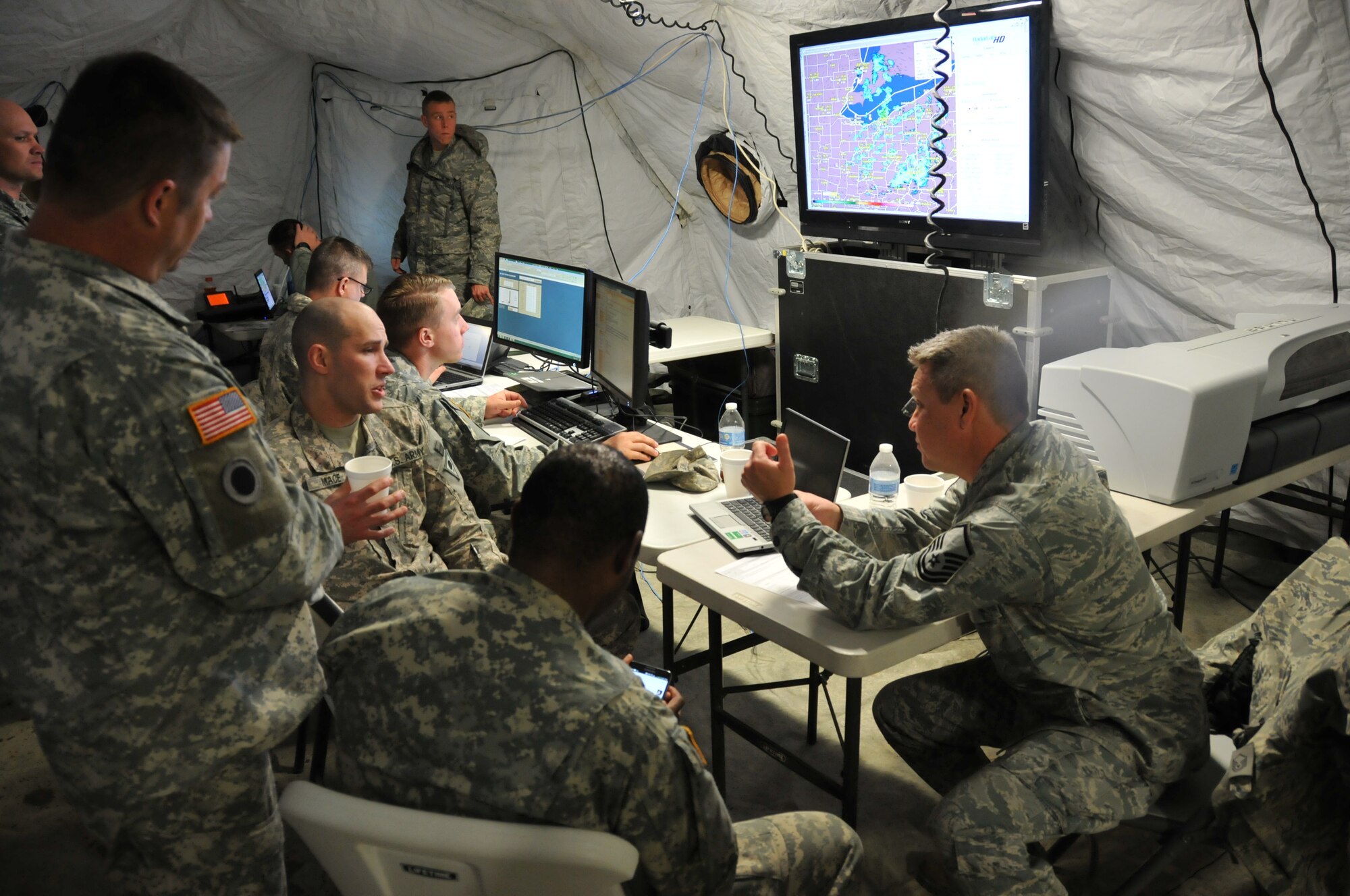 Master Sgt. Paul Wong, 125th Intelligence Squadron, works with soldiers of the 73rd Troop Command at the 200th RED HORSE Detachment 1, Mansfield, OH, as it is hosting a Homeland Emergency Response Force exercise May 3, 2014. Ohio Army National Guard 73rd Troop Command out of Rickenbacker, Columbus, form most of the H.E.R.F team with support from the 179th Airlift Wing, 269th Combat Communications Squadron and the 125th Intelligence Squadron out of Springfield. The joint forces exercise prepares FEMA Region 5 for a quick response to any regional emergency that arises. (U.S. Air National Guard Photo by TSgt Joseph Harwood \Released)