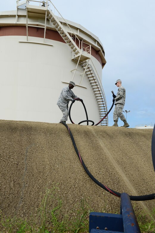 Airmen from the 633rd Civil Engineer Squadron Water, Fuel and System Maintenance shop perform an operational check on fuel hoses at Langley Air Force Base, Va., June 10, 2014. The check is part of a roughly two-week process where the fuel tank is cleaned, repaired, inspected and refilled with fuel. (U.S. Air Force Staff Sgt. Stephanie R. Plichta/Release) 