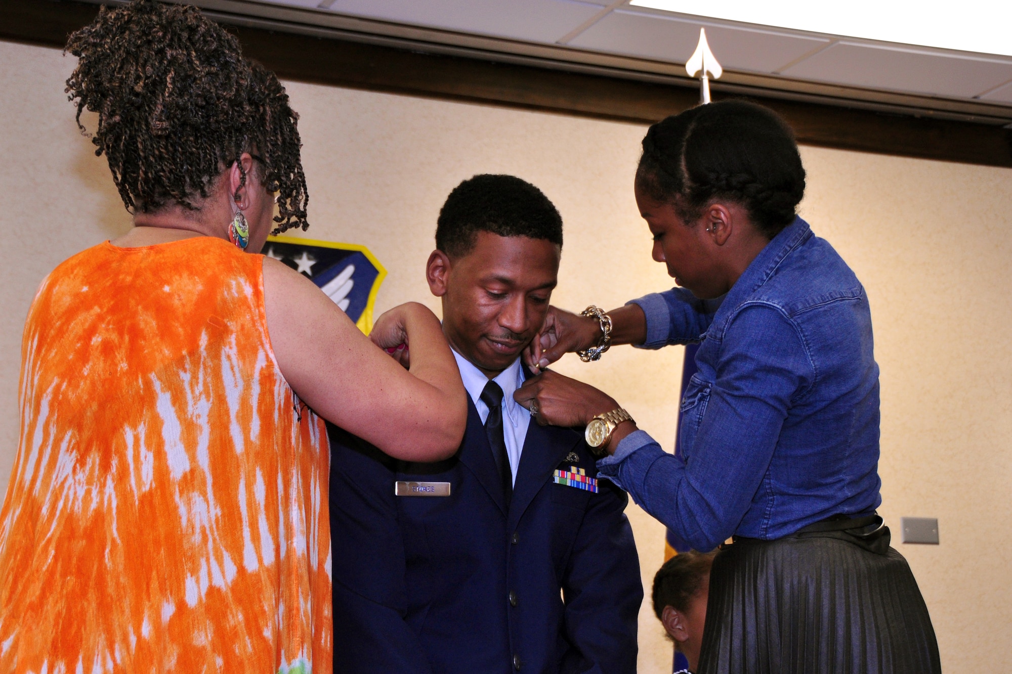 Craig Stokes, 916th Air Refueling Wing Equal Opportunity director, pins on the rank of Major with the help of his mother, Renee Gibbs, and wife, Andrita Stokes, in a ceremony held here over the June drill weekend. (USAF photo by Master Sgt. Wendy Lopedote, 916ARW/PA)