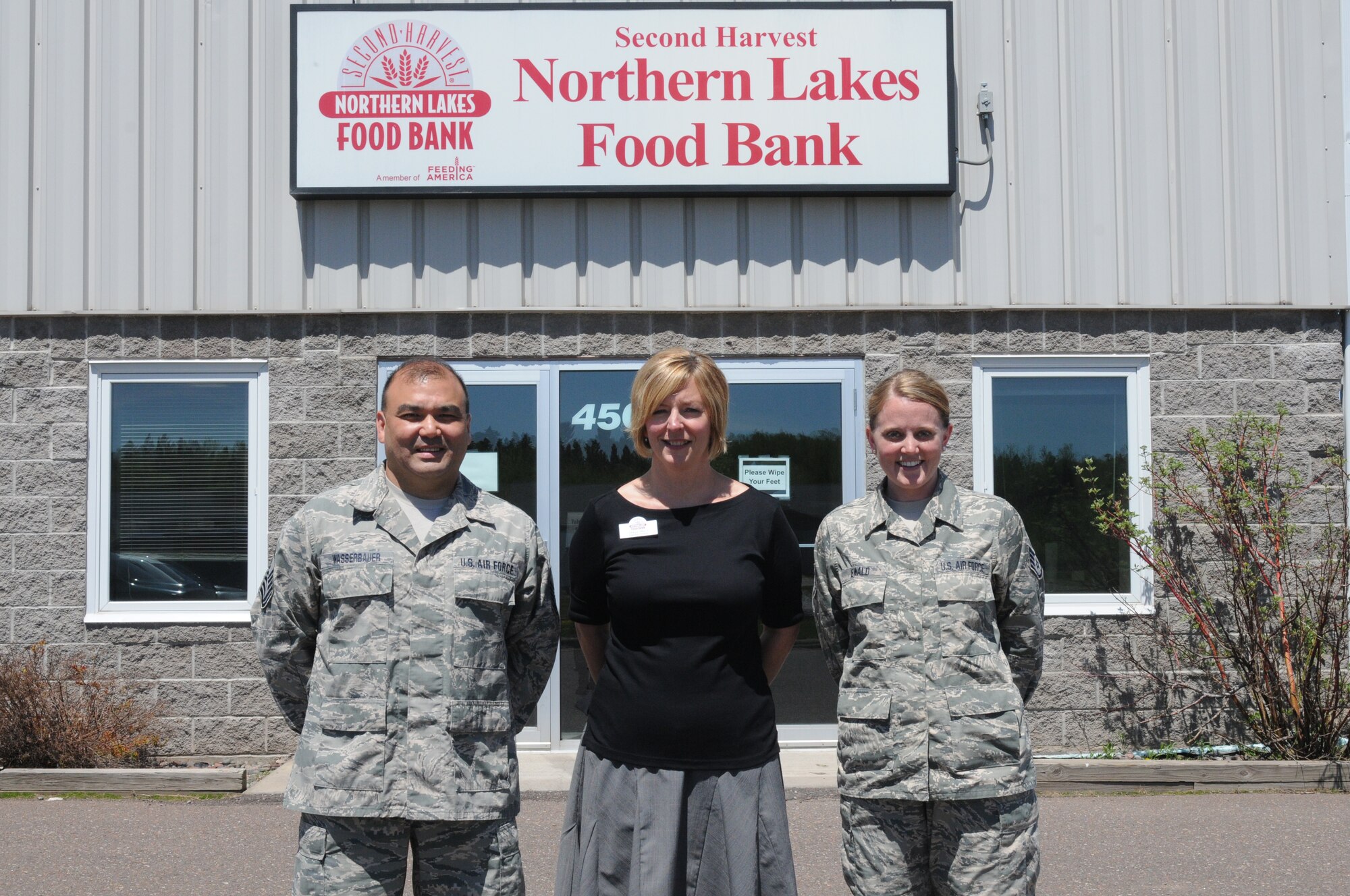Master Sgt. Mark Wasserbauer and Staff Sgt. Amy Ewald, 148th Fighter Wing, Base Enlisted Council (BEC) pose for a picture with