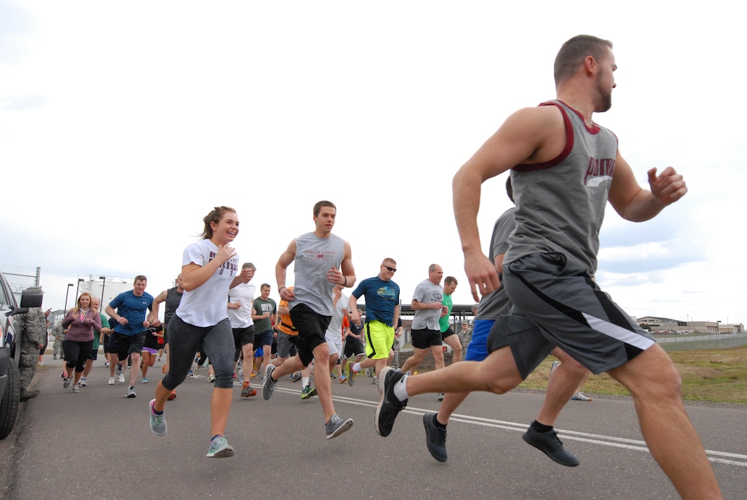 148th Fighter Wing members take off from the starting line while participating in the Fifth Annual 5K Meatball Run, 148th Fighter Wing, Duluth, Minn., May 18, 2014.  Most of the proceeds from the event go to support a local food bank in the Duluth, Minn. area, plus it gets members into the fitness frame of mind after a long winter.  (U.S. Air National Guard photo by Staff Sgt. Donald Acton/Released)