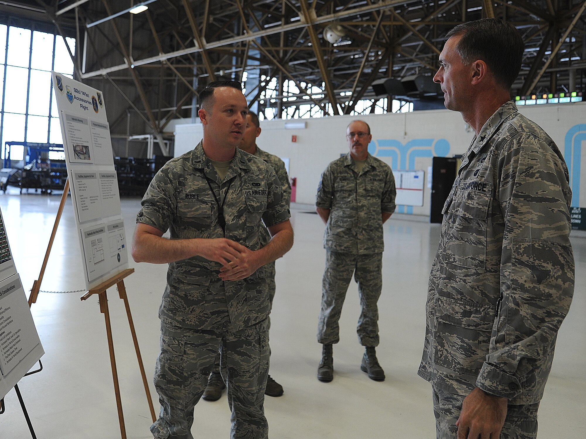 1st Lt. Paul Ruble briefs Brig. Gen. Warren D. Berry during his tour of Fairchild Air Force Base, Wash., June 10, 2014. During Berry’s visit to Team Fairchild, he was briefed on the maintenance and logistic squadrons’ mission. Ruble is from the 92nd Maintenance Squadron and Berry is the Air Mobility Command director of logistics. (U.S. Air Force photo by Staff Sgt. Samantha Krolikowski/Released)