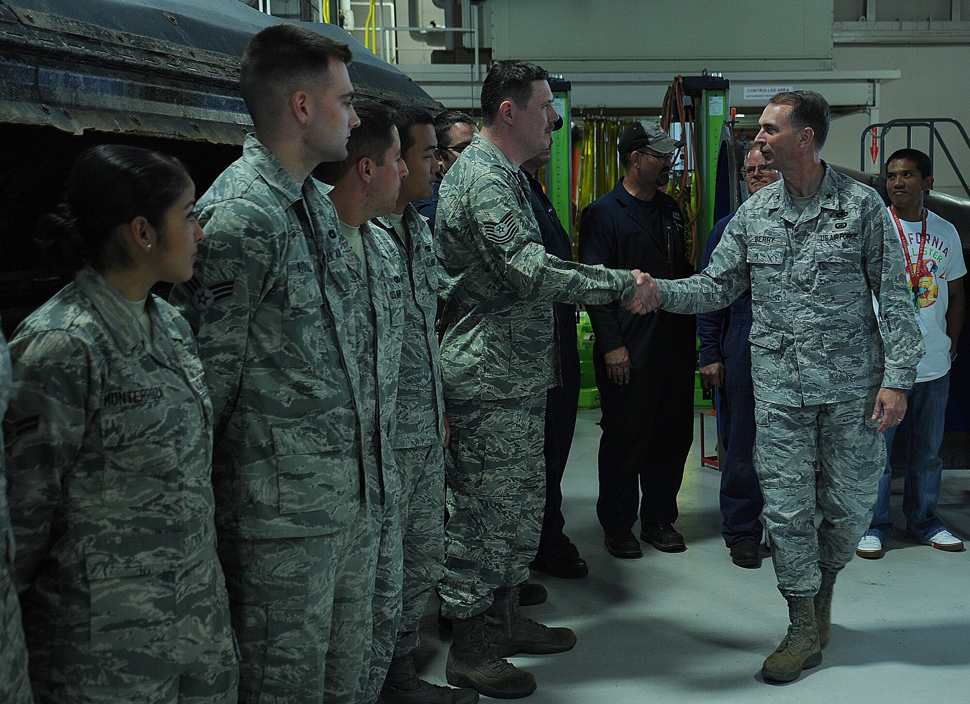 Brig. Gen. Warren D. Berry greets Airmen from the 92nd Logistics Readiness Squadron at Fairchild Air Force Base, Wash., June 10, 2014. During Berry’s visit to Team Fairchild, he was briefed on the maintenance and logistic squadrons’ mission. Berry the Air Mobility Command director of logistics. (U.S. Air Force photo by Staff Sgt. SamanthaKrolikowski/Released)