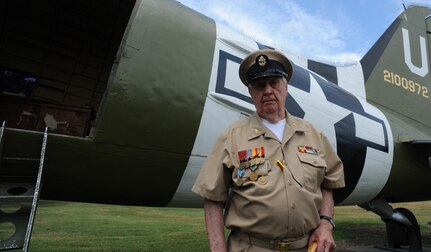 Retired Navy Chief Petty Officer Arlington Sandford, stands in front of a C-47 Skytrain during a visit on June 6, 2014, in honor of the 70th Anniversary of D-Day at Joint Base Charleston, S.C. Sandford served during D-Day.  (U.S. Air Force photo/ Staff Sgt. William A. O’Brien)
