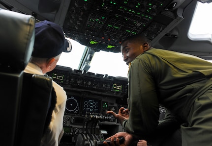 Capt. Jared Baxley, 16th Airlift Squadron pilot, gives Retired Army Air Force Lt. Col. Don Wallace, a C-47 Skytrain pilot, United States Air Force C-47 Skytrain pilot, a tour of the cockpit of a C-17. Wallace was at Joint Base Charleston in honor of the 70th Anniversary of D-Day. (U.S. Air Force photo/ Staff Sgt. William A. O’Brien)