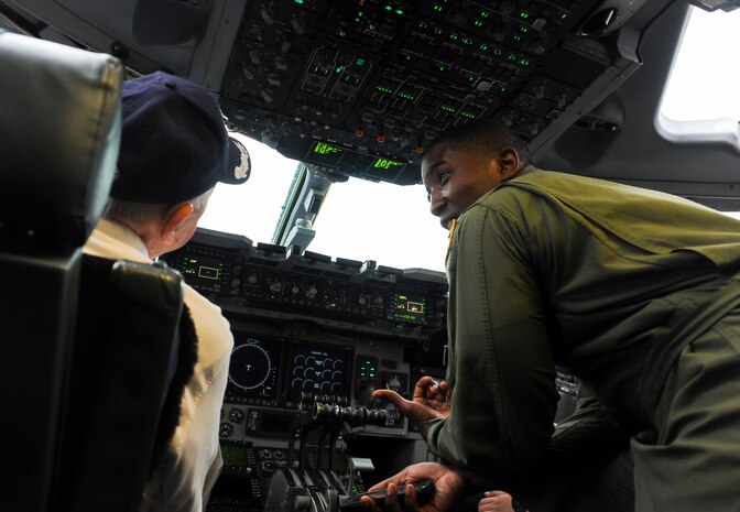 Capt. Jared Baxley, 16th Airlift Squadron pilot, gives Retired Army Air Force Lt. Col. Don Wallace, a C-47 Skytrain pilot, United States Air Force C-47 Skytrain pilot, a tour of the cockpit of a C-17. Wallace was at Joint Base Charleston in honor of the 70th Anniversary of D-Day. (U.S. Air Force photo/ Staff Sgt. William A. O’Brien)