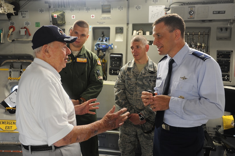 Retired Army Air Force Lt. Col. Don Wallace, a C-47 Skytrain pilot, talks to Col.  John Lamontagne, 437th Airlift wing commander, Chief Master Sgt. Shawn Hughes, 437th Airlift Wing command chief and Senior Airman Michael Denk, 16th Airlift Squadron crew chief.  Wallace was at Joint Base Charleston in honor of the 70th Anniversary of D-Day. (U.S. Air Force photo/ Staff Sgt. William A. O’Brien)