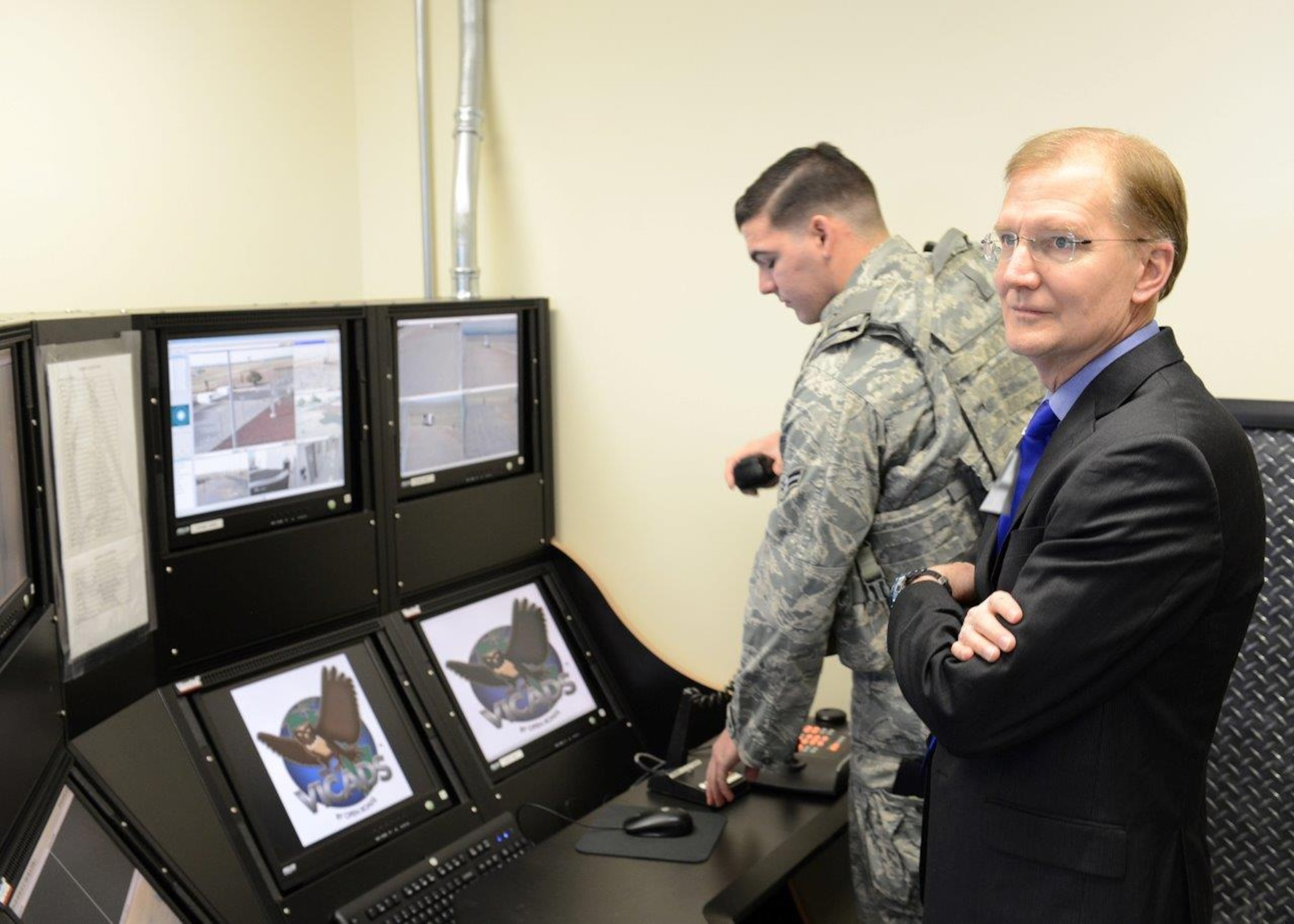 Senior Executive Service member Steven Wert, Battle Management program executive officer, monitors a security video feed alongside a 9th Reconnaissance Wing Security Forces Squadron Airman during a tour of the PAVE Phased Array Warning System radar site at Beale Air Force Base, Calif., May 7, 2014. The radar, which detects and tracks sea-launched and intercontinental ballistic missiles, received a security upgrade recently from Battle Management’s Force Protection Division at Hanscom AFB. (U.S. Air Force courtesy photo)
