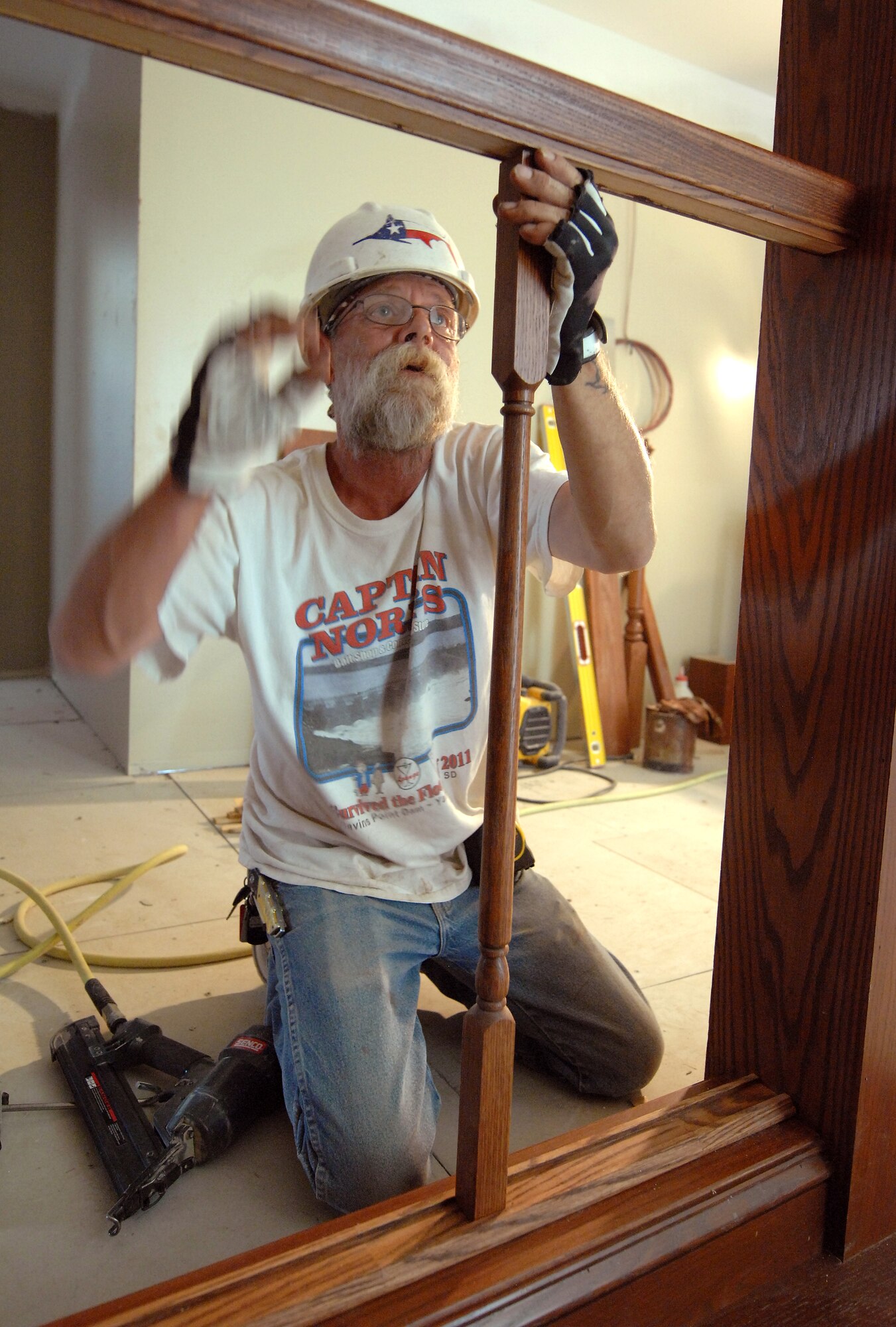 Jim Beggs, a contracted carpenter from South Sioux City, Iowa, completes finish work on a hand rail inside Building 49. The building, which was built in 1894, is receiving $5 million in renovations that are scheduled for completion later this summer. The updates will provide 32,000 square feet of office space for the 55th Mission Support Group and 55th Force Support Squadron. (U.S. Air Force photo/Delanie Stafford)