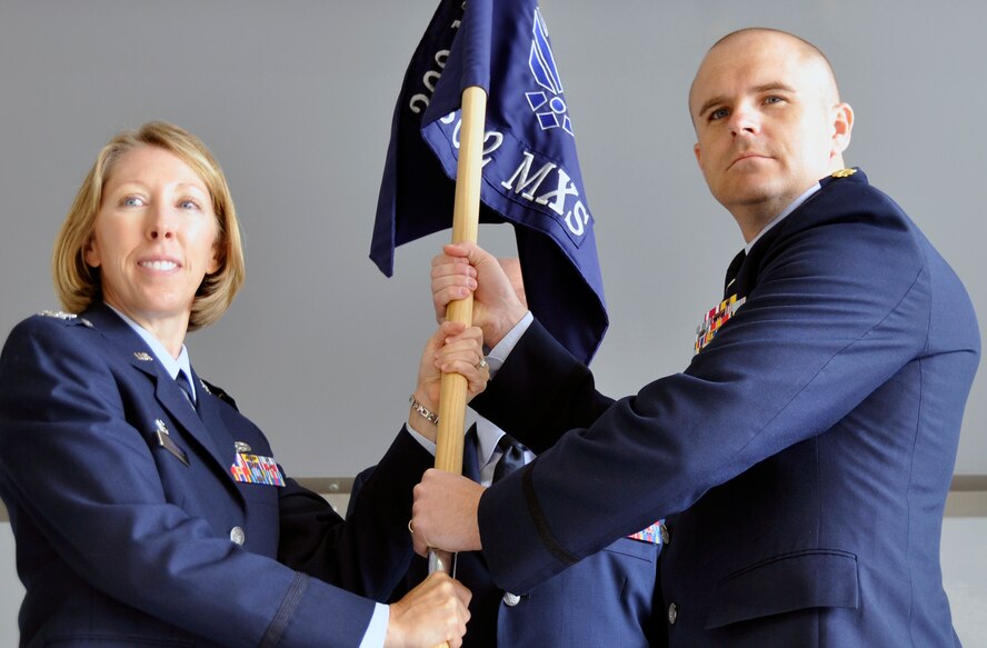 PETERSON AIR FORCE BASE, Colo. -- Maj. Michael Allen, accepts the 302nd Maintenance Squadron guideon from Col. Jennifer Cummings during a change of command ceremony June 7, 2014 here. Allen replaced Maj. Ryan Webster, who had commanded since Jan. 5, 2014. “He is a truly motivated leader, with foresight and integrity and he is the perfect choice to carry on what Maj Webster started,” said Cummings, 302nd Maintenance group commander. Previously Allen was the 302nd Maintenance Operations Flight Commander. (U.S. Air Force photo/Master Sgt. Daniel Butterfield)