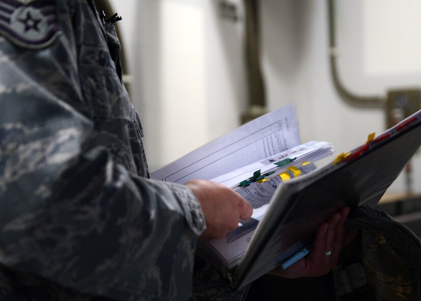 Staff Sgt. David Golab, 12th Missile Squadron facility manager, browses through a technical order while at India 1 missile alert facility. Golab follows daily checklists during his 72-hour tour at MAFs. (U.S. Air Force photo/Senior Airman Katrina Heikkinen)
