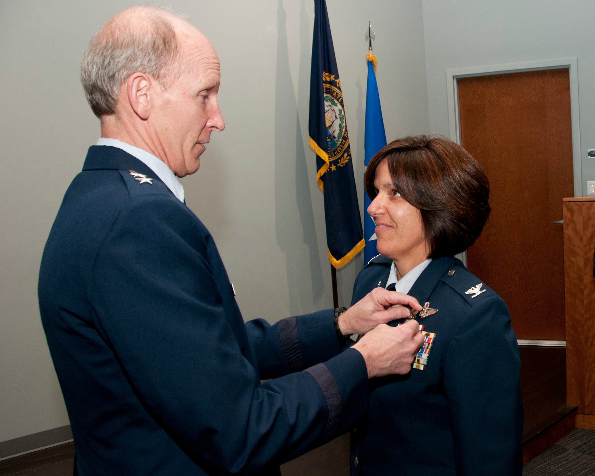 PEASE AIR NATIONAL GUARD BASE, N.H—Maj. Gen.  William N. Reddel III, The Adjutant  General of the New Hampshire National Guard presents Col. Nicole L. Desilets-Bixler with  the Legion of Merit during her retirement ceremony in building 264, on June 8, 2014. Bixler retires after 34 years of service and she has  the distinction of being on the first N.H. Guard all-female flight crew which flew veterans to the Woman's memorial in Washington D.C.  for its dedication. (U.S. Air National Guard photo by Staff Sgt. Curtis J. Lenz)