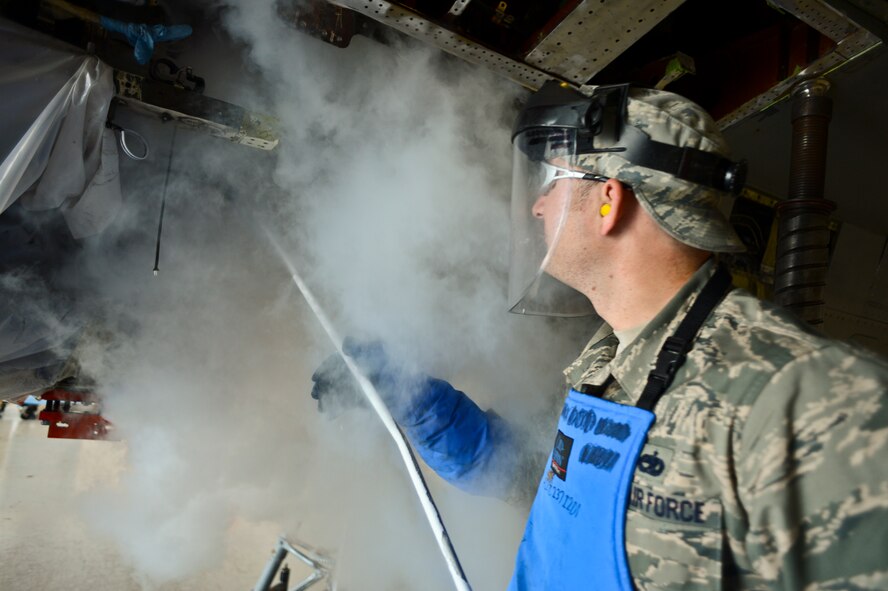 U.S. Air Force Staff Sgt. Paul Beatty, 309th Aircraft Maintenance Group structural aircraft maintenance technician, assigned to Hill Air Force Base, Utah, uses liquid nitrogen to clean out the bulkhead on one of the 20th Fighter Wing’s 82 F-16CJ Fighting Falcon’s at Shaw Air Force Base, S.C., June 11, 2014. Beatty and his team have been working to remove, clean out, and replace a bulkhead in the aircraft for the last month. The Hill Airmen are here because the extent of the repair exceeds what Shaw Airmen are allowed to do by Air Force regulations. (U.S. Air Force photo by Airman 1st Class Jonathan Bass/Released)