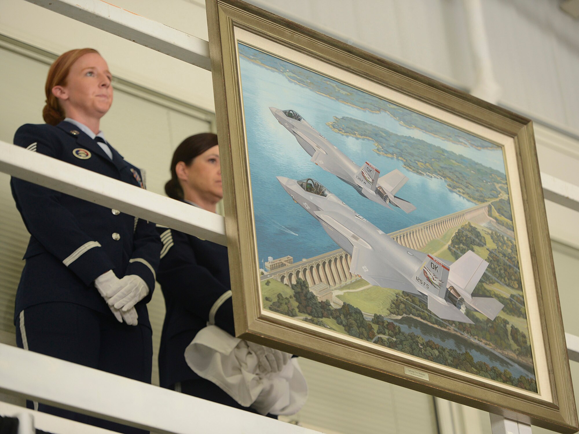 An oil painting of an F-35 with the 138th Fighter Wing tail flash is unveiled during a Commanders Call at the Tulsa Air National Guard base, June 8, 2014.  The painting is a symbol, in hope of a future mission that the 138th members and their senior leaders would like to have.  (U.S. National Guard photo by Master Sgt.  Mark A. Moore/Released)