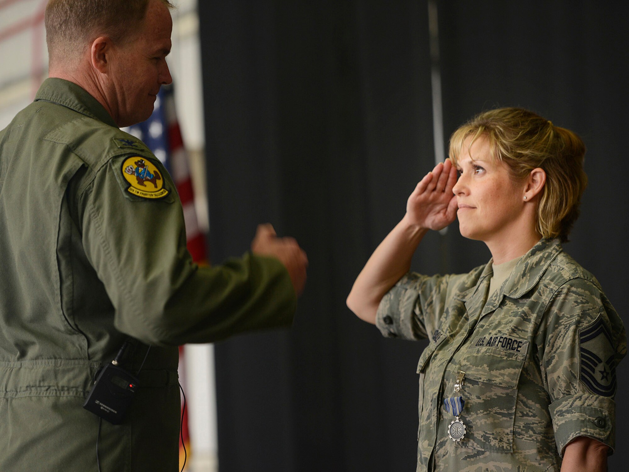 Colonel David B. Burgy, 138th Fighter Wing Commander, presents the U.S. Air Force Achievement Medal to Senior Master Sergeant Amanda Lonsdale for her outstanding work as a Family Assistance Officer.  The medal was presented during a Commanders Call at the Tulsa Air National Guard base, June 8, 2014.    (U.S. National Guard photo by Master Sgt.  Mark A. Moore/Released)