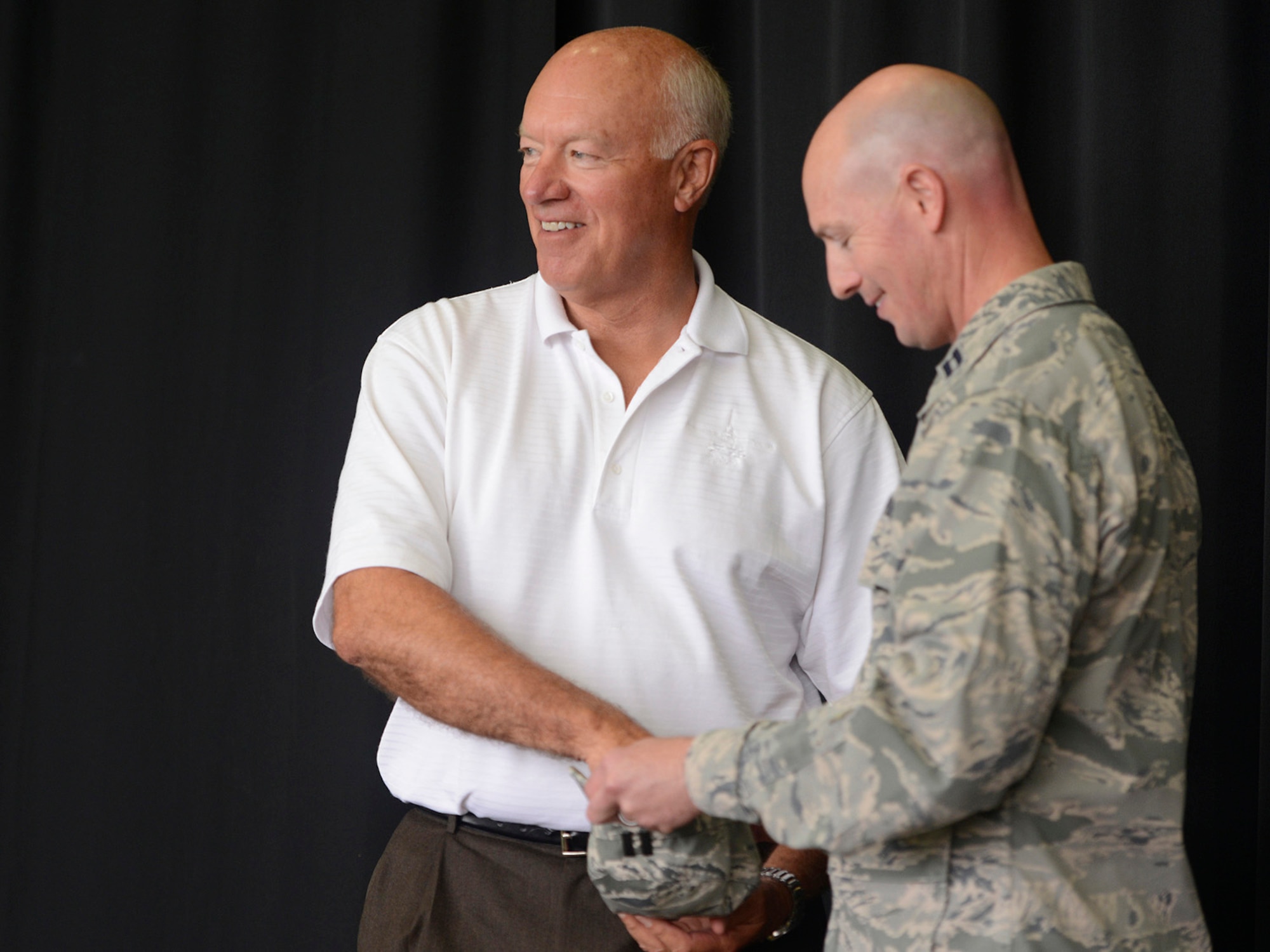 During a Commanders Call at the Tulsa Air National Guard base, June 8, 2014, former Director of the Air National Guard, Lieutenant General Harry M. (Bud) Wyatt III (Ret.), draws the winning name of a 138th Fighter Wing recruiting challenge.   Colonel David B. Burgy, 138th FW Commander, regularly issues the recruiting challenge to members of the 138th and includes a monetary award as incentive.   (U.S. National Guard photo by Master Sgt.  Mark A. Moore/Released)