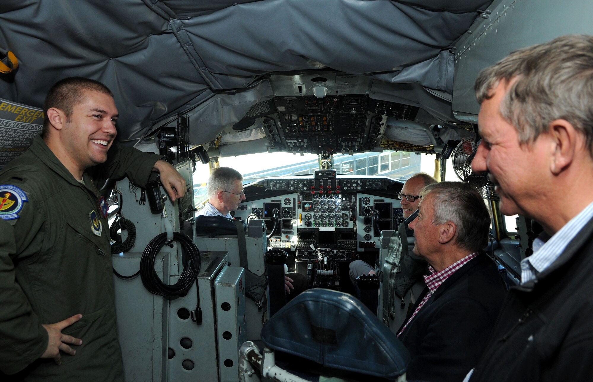 U.S. Air Force 1st Lt. Jack Ryan, left, 351st Air Refueling Squadron co-pilot from Chaska, Minn., explains the duties and responsibilities of his job to representatives from local off-base businesses June 10, 2014, during a tour on RAF Mildenhall, England. The representatives visited the base for an intimate breakfast with Team Mildenhall commanders to facilitate networking, followed by a short tour of the base and a KC-135 Stratotanker static display to better communicate the mission and purpose of RAF Mildenhall. (U.S. Air Force photo/Senior Airman Kate Maurer/Released)