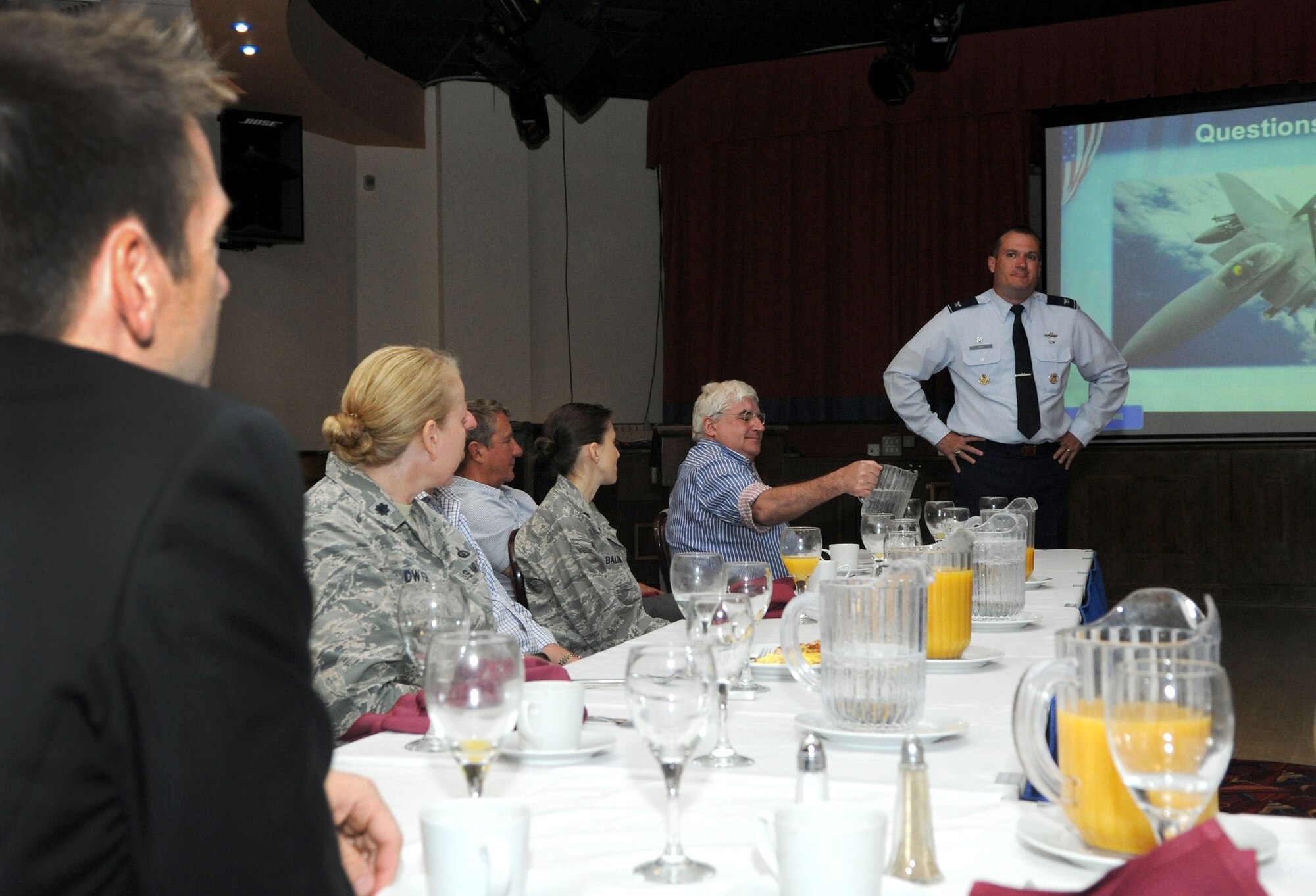 U.S. Air Force Col. Kenneth T. Bibb, Jr., 100th Air Refueling Wing commander, answers questions after a mission briefing during a business breakfast June 10, 2014, in the Galaxy Club on RAF Mildenhall, England. The breakfast gave representatives from local off-base businesses the opportunity to learn more about RAF Mildenhall and ask any questions they had straight to the commanders to help foster trust and community relations. (U.S. Air Force photo/Senior Airman Kate Maurer/Released)