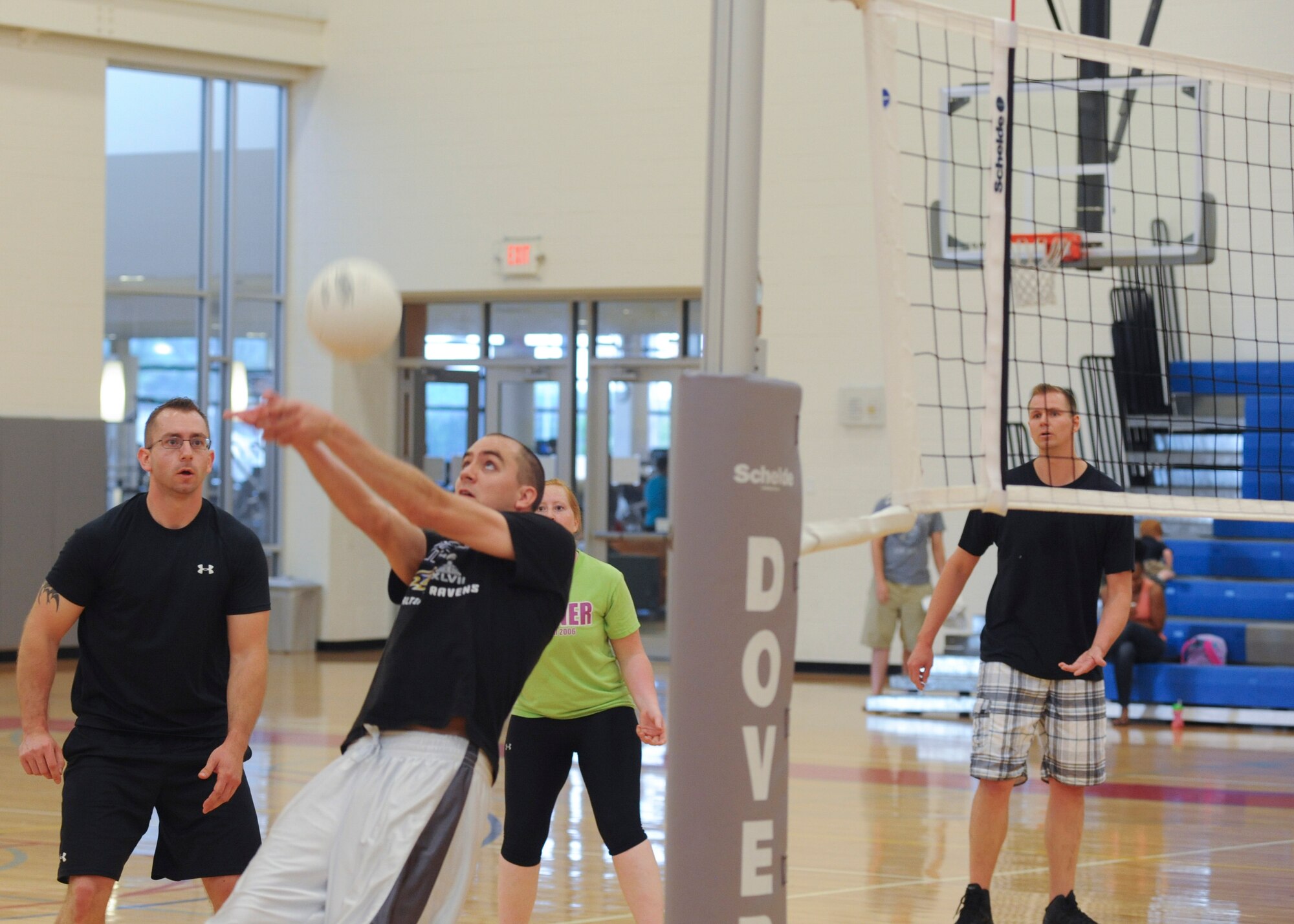 Joel Loftus, 436th Operations Group, volleys the ball during an intramural championship volleyball game June 6, 2014, at the fitness center on Dover Air Force Base, Del. The OG was able to pull the championship out by winning the crucial fifth game against the 436th Aircraft Maintenance Squadron. (U.S. Air Force photo/Senior Airman Jared Duhon) 