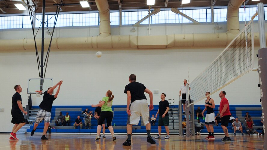 Ryan Mozingo, 436th Operations Group, returns a serve from the 436th Aircraft Maintenance Squadron team during an intramural championship volleyball game June 6, 2014, at the fitness center on Dover Air Force Base, Del. The two teams faced off in a fierce battle totaling five games with the Ops Group coming out victorious. (U.S. Air Force photo/Senior Airman Jared Duhon) 