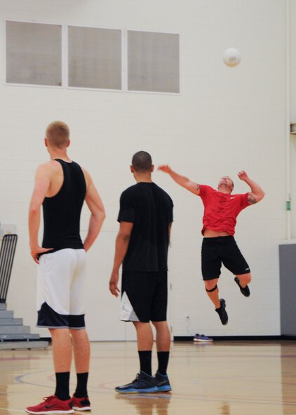 Jason Whitaker, 436th Aircraft Maintenance Squadron coach, serves the ball during an intramural championship volleyball game June 6, 2014, at the fitness center on Dover Air Force Base, Del. The 436th AMXS put up a good fight but lost to the 436th Operations Group in the championship game. (U.S. Air Force photo/Senior Airman Jared Duhon)